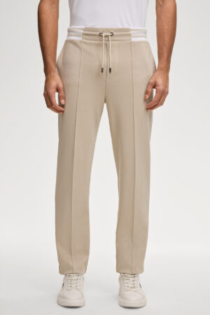 Bēšas sportiskā stila bikses ar svītru akcentu